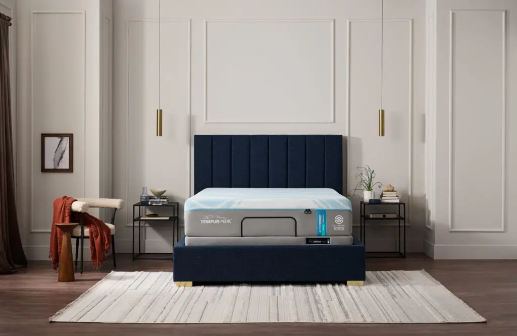 Tempur-Pedic mattress on a stylish bed frame in a modern bedroom setting, showcasing advanced cooling technology and elegant decor, relevant to Jacksonville Bedding's Grand Opening promotions.