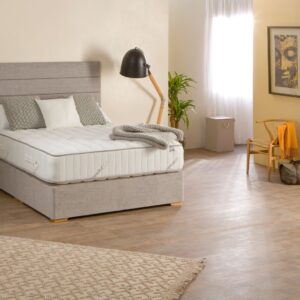 King Koil Alder plush tight top mattress displayed in a modern bedroom setting with neutral decor, featuring a cozy blanket and decorative pillows, emphasizing comfort and style for quality sleep.