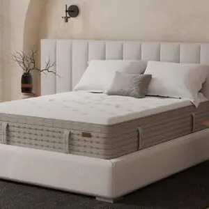 King Koil Terra Firm Euro Top mattress on a modern bed frame with decorative pillows, showcasing a sleek design suitable for premium bedding options.