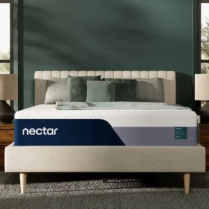Nectar memory foam mattress displayed on a stylish bed frame in a well-lit bedroom setting, featuring decorative pillows and a modern aesthetic.