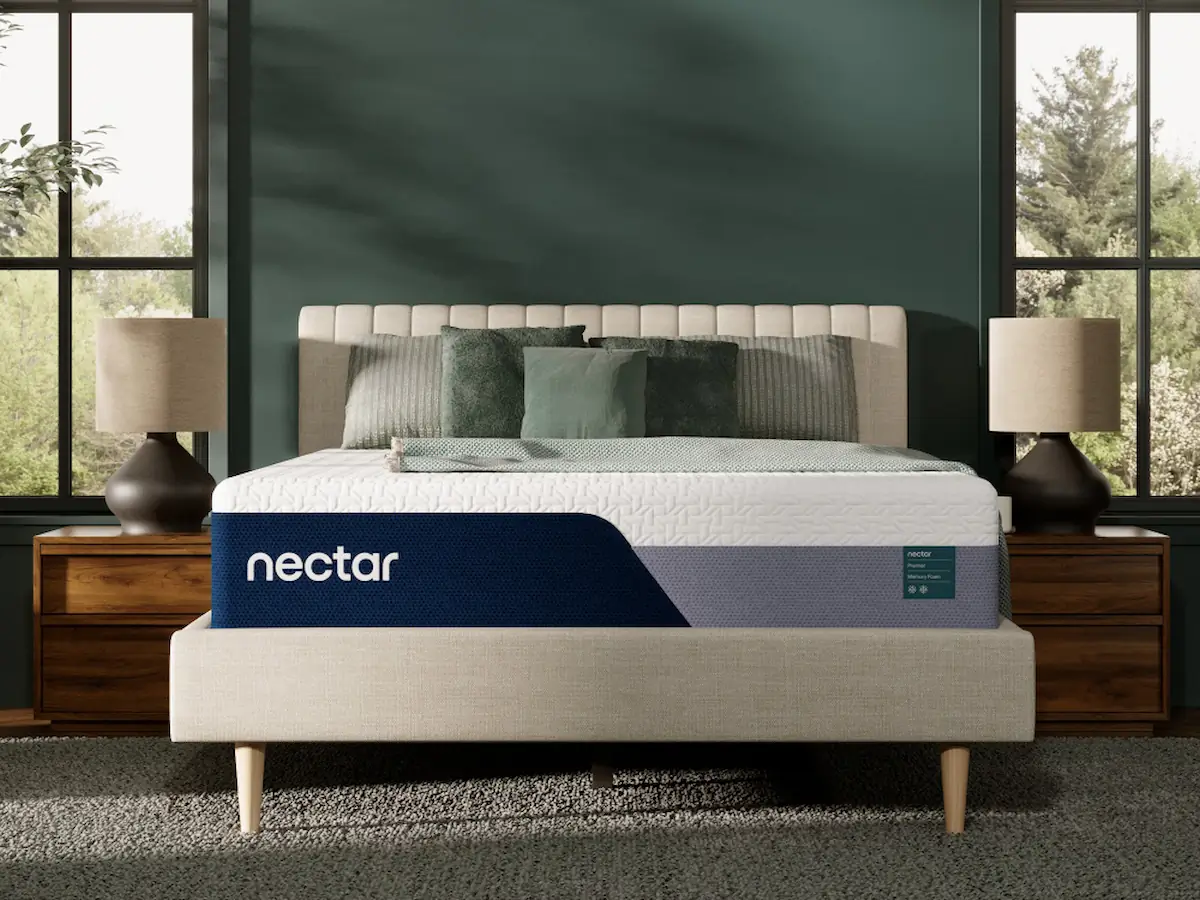 Nectar Premier Memory Foam 1 Nectar Premier Memory Foam mattress on a stylish bed frame in a modern bedroom setting, featuring decorative pillows and bedside lamps, highlighting its cooling and comfort features.