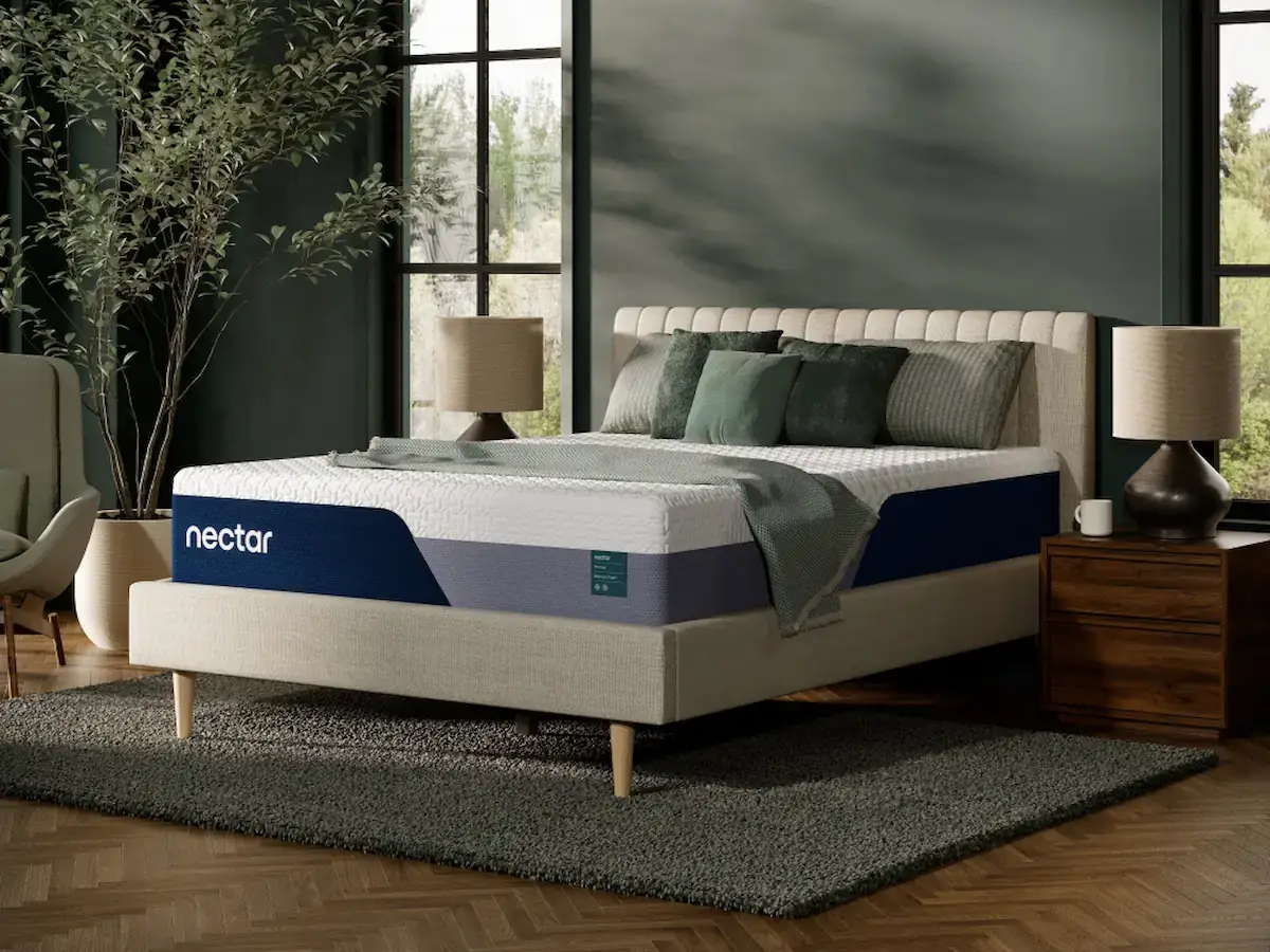 Nectar Premier Memory Foam 2 Nectar Premier Memory Foam mattress on a stylish bed frame in a modern bedroom setting, featuring decorative pillows and a cozy atmosphere, highlighting its comfort and design appeal.