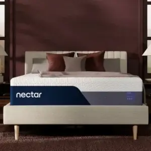 Nectar mattress displayed on a stylish bed frame with decorative pillows, showcasing the brand's focus on comfort and quality bedding solutions.